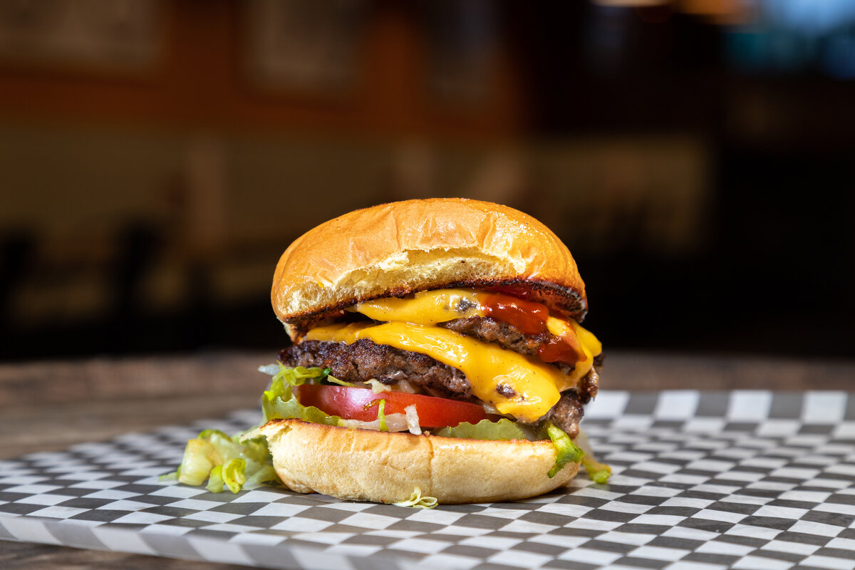 The Blueprint - Two American Wagyu patties, American cheese, lettuce, tomato, pickle, ketchup, and mustard. on a Martin's Potato bun.