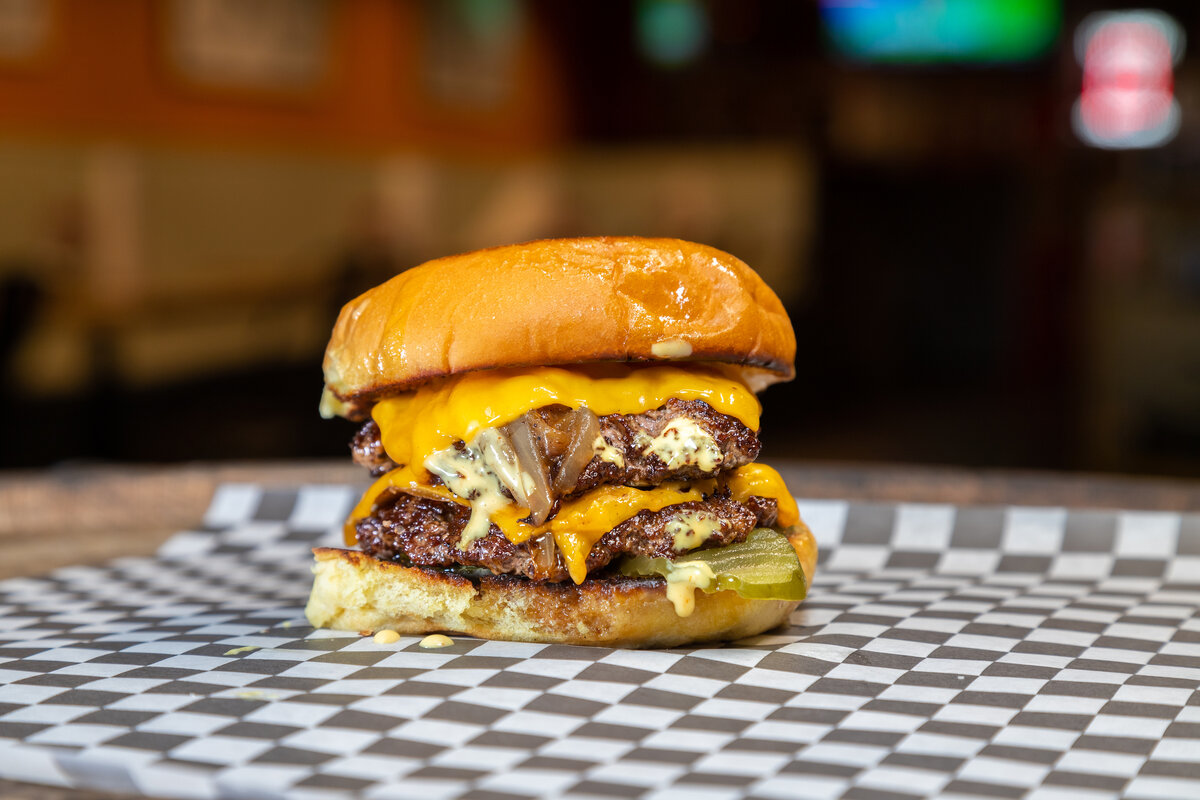 The Foxtrot - Two grilled American Wagyu beef patties with caramelized onions, cheese, pickle and Foxtrot sauce.